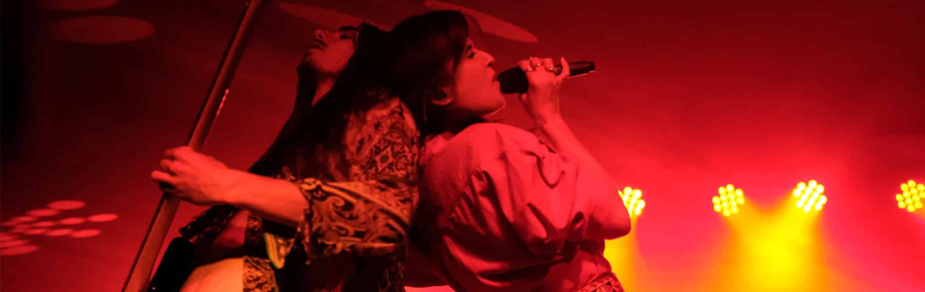 Performing duet one singing and one on the guitar on stage while using Galaxy Audio wireless personal in-ear monitors.